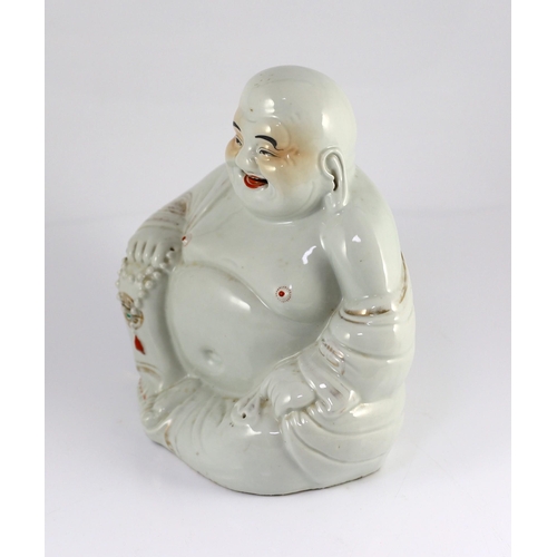 147 - A Chinese porcelain figure of Budai, Republic period, holding a rosary in his right hand, his robe i... 