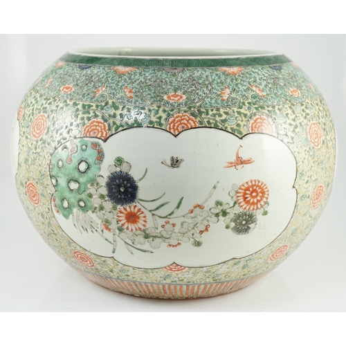 151 - A large Chinese famille verte jardiniere or fish bowl, 19th century, painted to four reserves with a... 