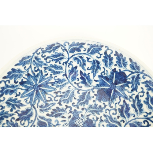 158 - A Chinese blue and white dish, Kangxi mark, 19th century, the centre painted with four pomegranates ... 