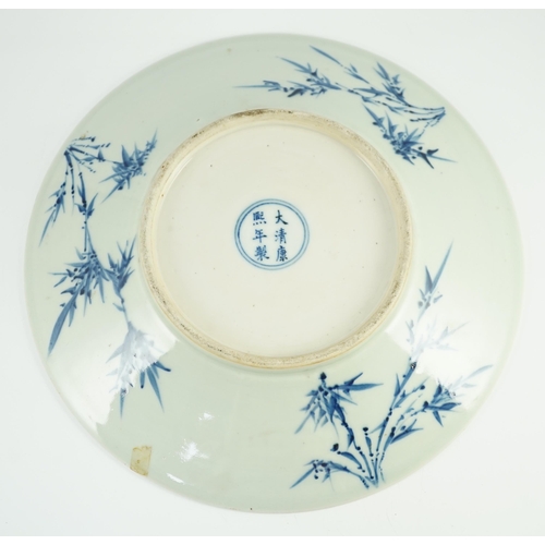 158 - A Chinese blue and white dish, Kangxi mark, 19th century, the centre painted with four pomegranates ... 