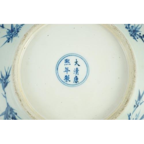 158 - A Chinese blue and white dish, Kangxi mark, 19th century, the centre painted with four pomegranates ... 