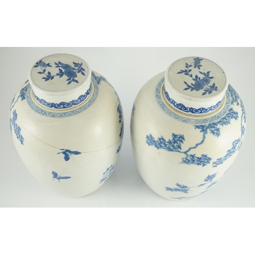 165 - A pair of large Chinese blue and white ovoid jars and associated covers, 19th century, each painted ... 