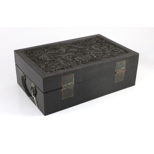 173 - A Chinese hardwood 'dragon' box, possibly zitan, late 19th/early 20th century, the rectangular cover... 