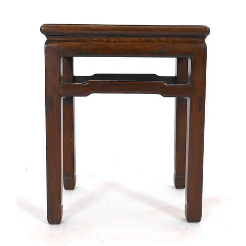 174 - A Chinese huanghuali and hongmu stool, 18th/19th century, the panelled rectangular top above a round... 