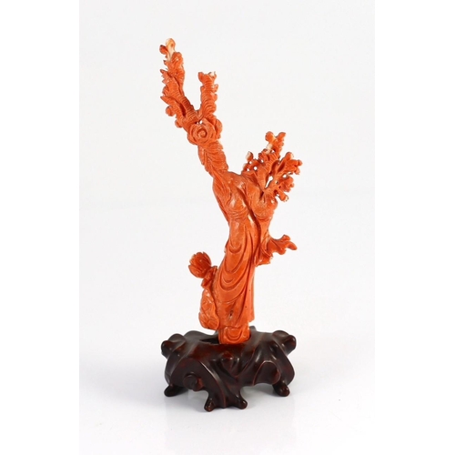 175 - A Chinese carved coral figure of a flower fairy, 20th century, the figure holding a vase of flowers ... 