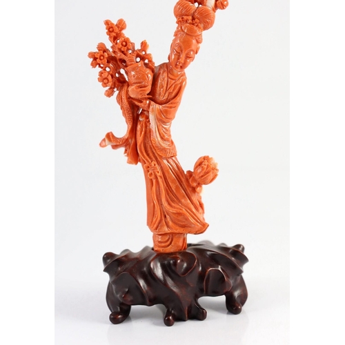 175 - A Chinese carved coral figure of a flower fairy, 20th century, the figure holding a vase of flowers ... 