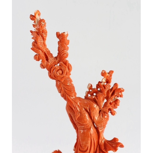 175 - A Chinese carved coral figure of a flower fairy, 20th century, the figure holding a vase of flowers ... 