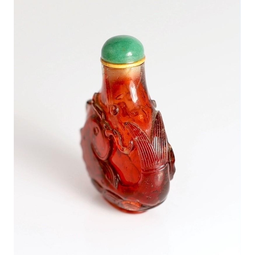 182 - A Chinese ruby red glass leaping carp snuff bottle, 1750-1850, each side carved in high relief wit... 