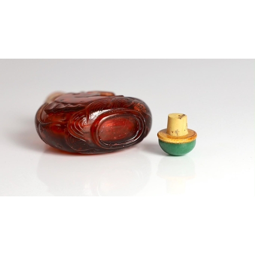 182 - A Chinese ruby red glass leaping carp snuff bottle, 1750-1850, each side carved in high relief wit... 