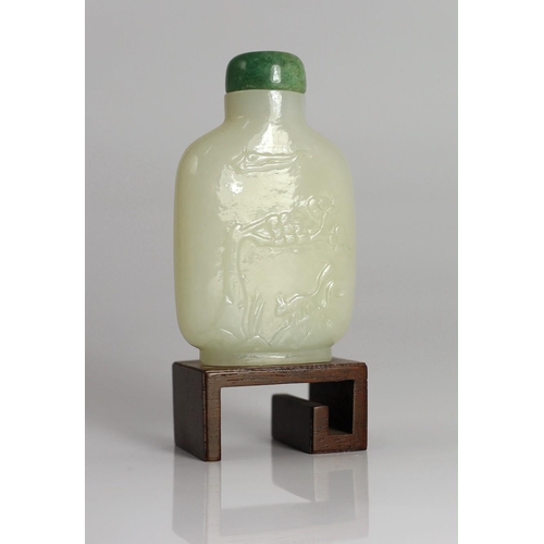 186 - A Chinese white jade snuff bottle, 19th/20th century, carved in relief with a squirrel on rockwork b... 