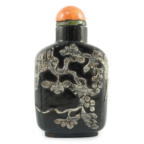 190 - A Chinese smoky quartz snuff bottle, 1780-1820, of flattened shield shape, the carver skilfully usin... 