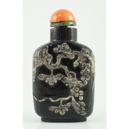 190 - A Chinese smoky quartz snuff bottle, 1780-1820, of flattened shield shape, the carver skilfully usin... 