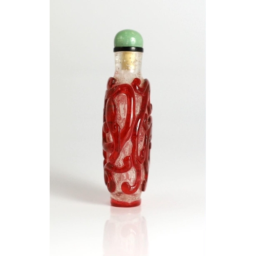 193 - A Chinese ruby red overlay on snowflake ground snuff, 1750-1850, deeply carved with scrolling chilon... 