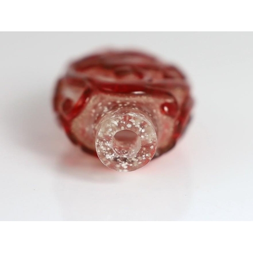 193 - A Chinese ruby red overlay on snowflake ground snuff, 1750-1850, deeply carved with scrolling chilon... 