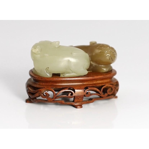 211 - A Chinese pale celadon and brown jade group of two cats, 19th century, 5.1cm, wood stand, tiny chips... 