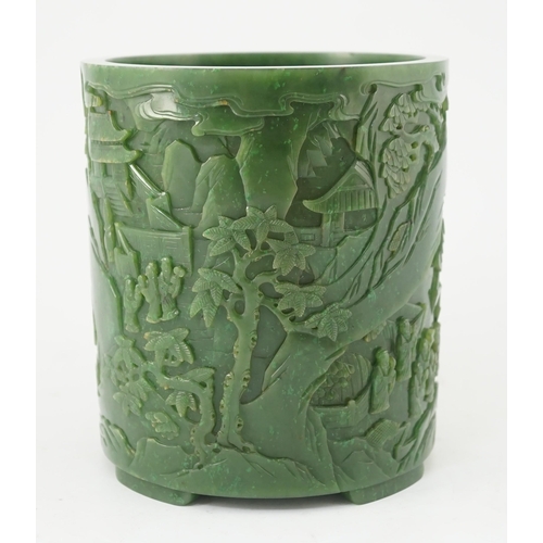 215 - A large Chinese spinach green jade brushpot, bitong, carved in relief with scholars amid pavilions, ... 