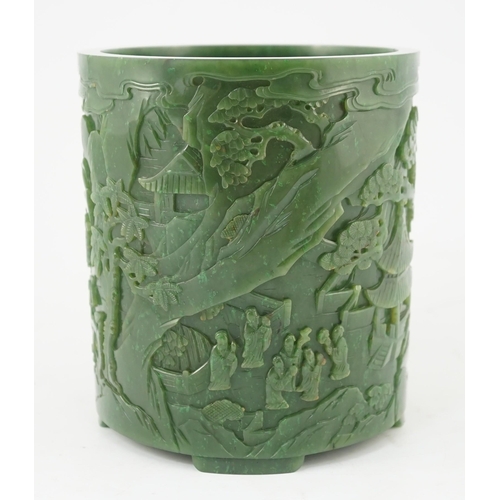 215 - A large Chinese spinach green jade brushpot, bitong, carved in relief with scholars amid pavilions, ... 