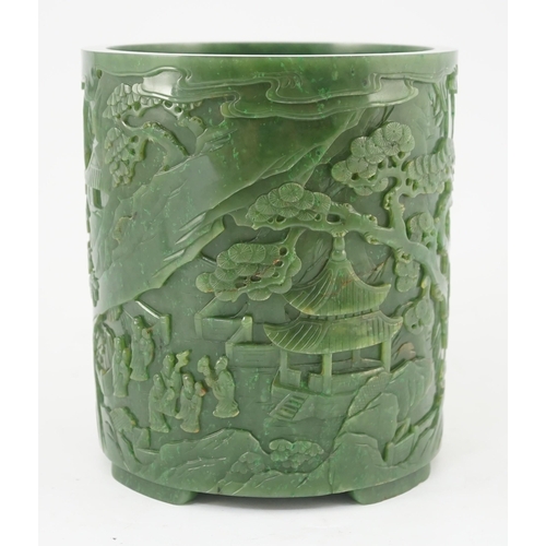 215 - A large Chinese spinach green jade brushpot, bitong, carved in relief with scholars amid pavilions, ... 