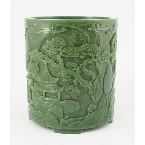 215 - A large Chinese spinach green jade brushpot, bitong, carved in relief with scholars amid pavilions, ... 