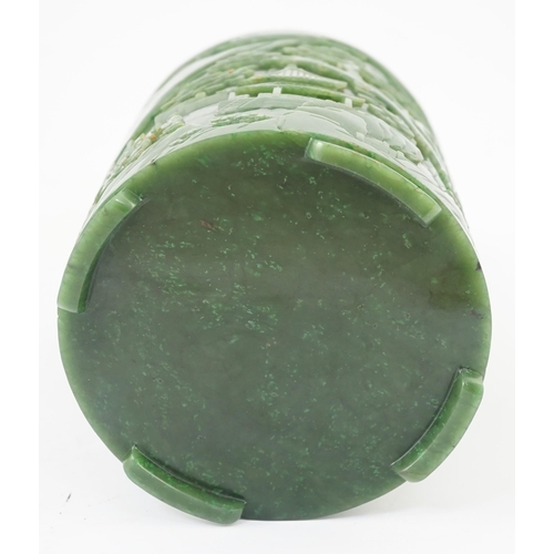 215 - A large Chinese spinach green jade brushpot, bitong, carved in relief with scholars amid pavilions, ... 