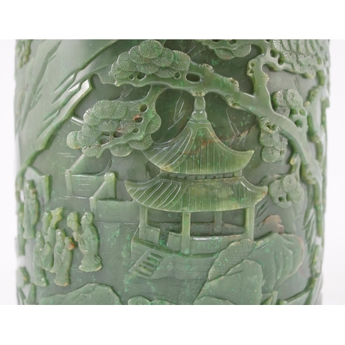 215 - A large Chinese spinach green jade brushpot, bitong, carved in relief with scholars amid pavilions, ... 