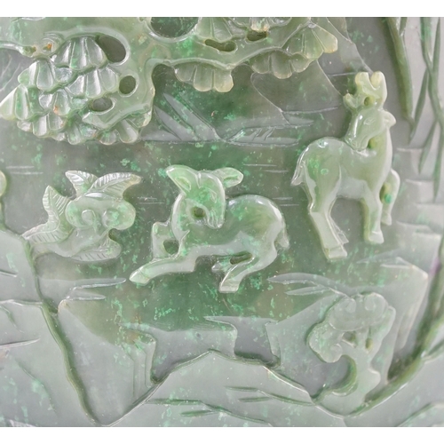 215 - A large Chinese spinach green jade brushpot, bitong, carved in relief with scholars amid pavilions, ... 