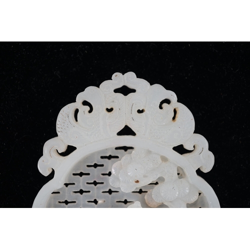 216 - A Chinese white jade reticulated plaque, 19th century, carved in high relief and openwork with a sag... 