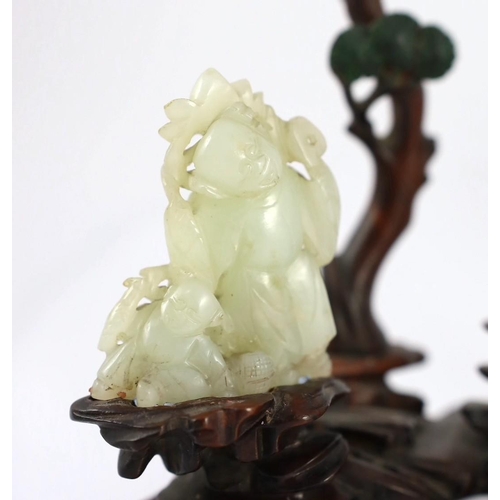 217 - An assembled group of four Chinese pale celadon jade figures, 18th/19th century, the first a group o... 