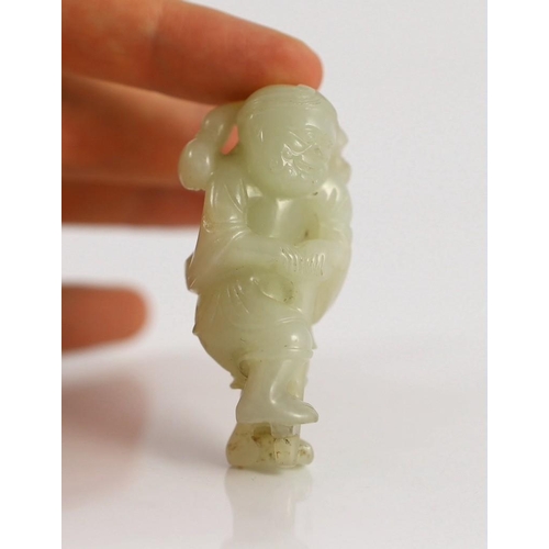 217 - An assembled group of four Chinese pale celadon jade figures, 18th/19th century, the first a group o... 