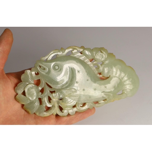 218 - A Chinese pale celadon jade 'fish' plaque, 18th/19th century, carved and pierced with a leaping fish... 