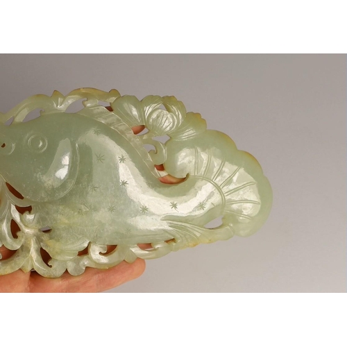 218 - A Chinese pale celadon jade 'fish' plaque, 18th/19th century, carved and pierced with a leaping fish... 