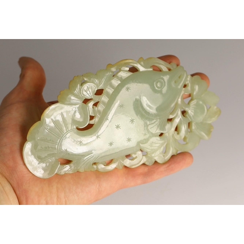 218 - A Chinese pale celadon jade 'fish' plaque, 18th/19th century, carved and pierced with a leaping fish... 