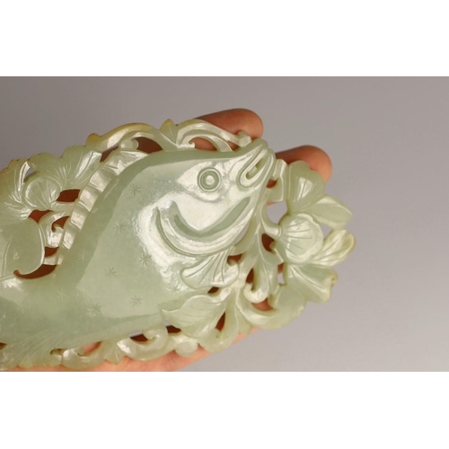 218 - A Chinese pale celadon jade 'fish' plaque, 18th/19th century, carved and pierced with a leaping fish... 