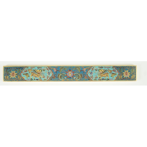 225 - A Chinese cloisonné enamel and gilt bronze scroll weight, decorated in colours with two qilin, lotus... 