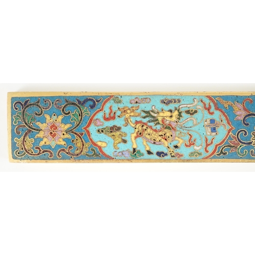 225 - A Chinese cloisonné enamel and gilt bronze scroll weight, decorated in colours with two qilin, lotus... 