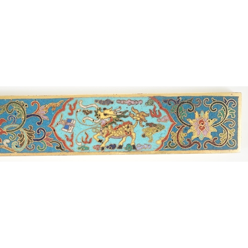 225 - A Chinese cloisonné enamel and gilt bronze scroll weight, decorated in colours with two qilin, lotus... 