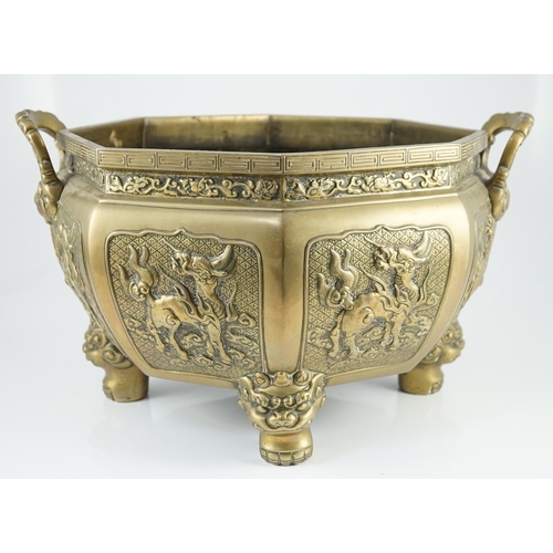 227 - A large Chinese polished bronze octagonal jardiniere, 19th century, each side cast in relief with a ... 