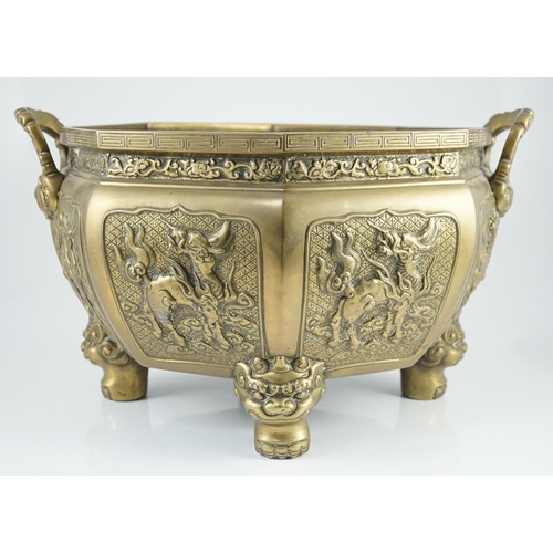 227 - A large Chinese polished bronze octagonal jardiniere, 19th century, each side cast in relief with a ... 