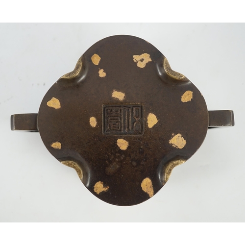 229 - A Chinese gold splashed bronze quatrelobed censer, dark brown patinated with gold splashes, applied ... 