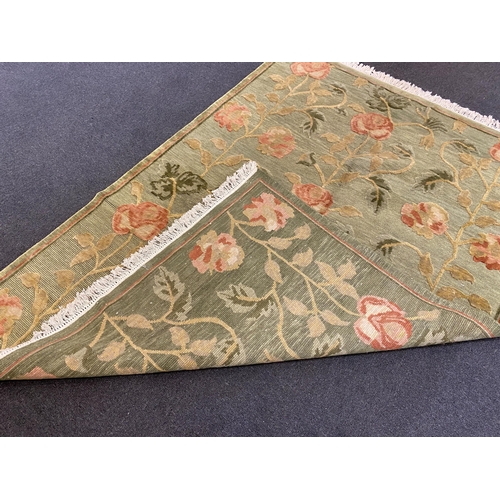 249 - A Tibetan pale green ground carpet, with bold floral field, 250cm x 176cm