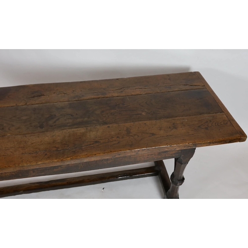 255 - A Charles I oak refectory table, c.1630, the triple plank top with cleated ends, the four unusual tw... 