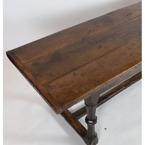 255 - A Charles I oak refectory table, c.1630, the triple plank top with cleated ends, the four unusual tw... 