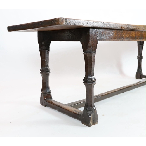 255 - A Charles I oak refectory table, c.1630, the triple plank top with cleated ends, the four unusual tw... 