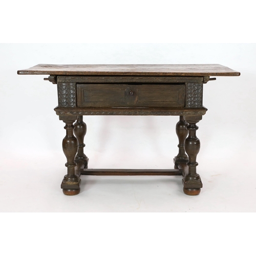 256 - A late 17th century Dutch oak side table, with rectangular top and frieze drawer, on baluster legs w... 