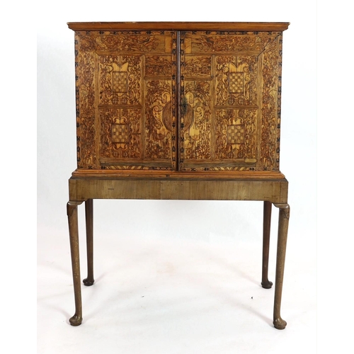 258 - A 17th century and later South German walnut and marquetry cabinet on later stand, with moulded corn... 