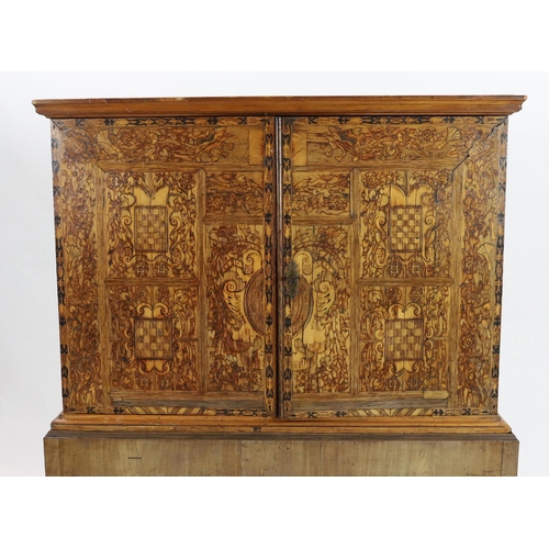 258 - A 17th century and later South German walnut and marquetry cabinet on later stand, with moulded corn... 