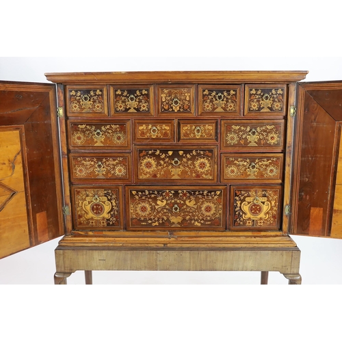 258 - A 17th century and later South German walnut and marquetry cabinet on later stand, with moulded corn... 