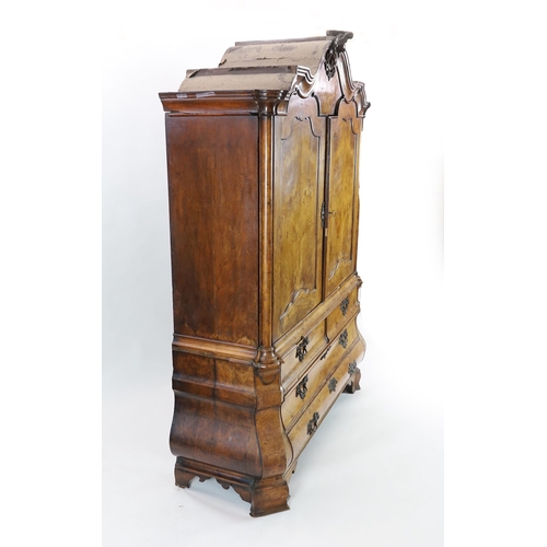 263 - An 18th century Dutch walnut armoire, with scroll moulded cornice and two panelled doors enclosing p... 