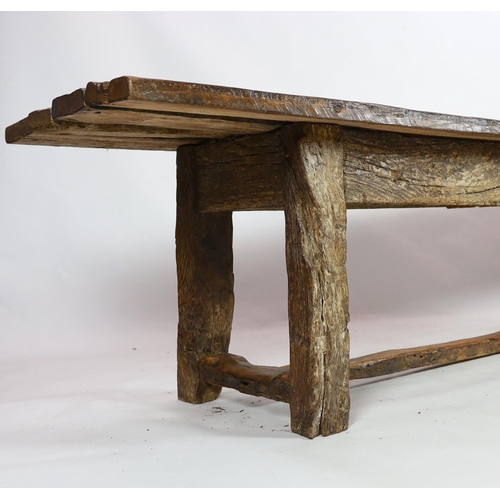 265 - A rustic oak four plank top refectory table, constructed from old floorboards and other timbers, on ... 