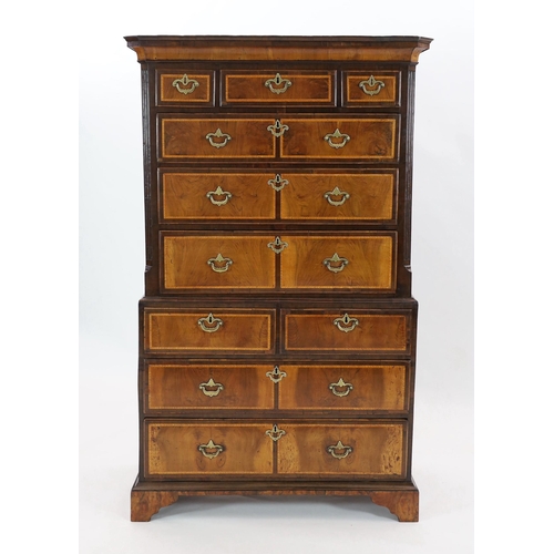 267 - A George II featherbanded walnut chest on chest, with moulded cornice, three short and three graduat... 